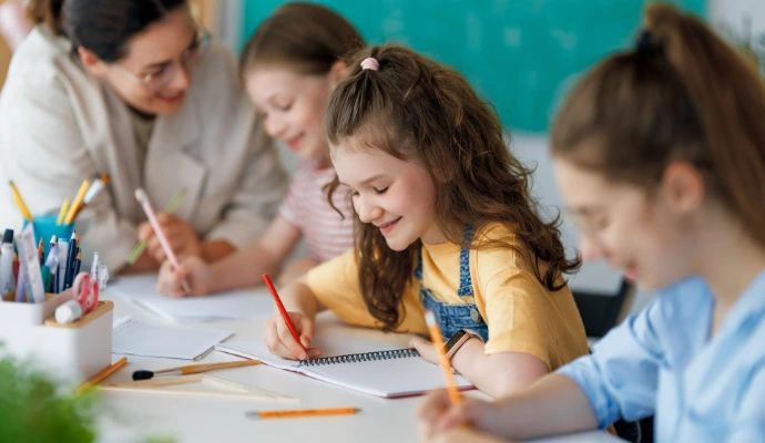 child writing in school classroom environment 