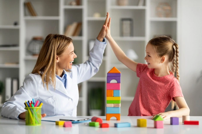 Child high-fiving the teacher in a positive environment